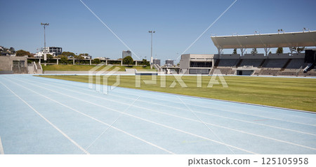 Race track, athletic and empty outdoor sports stadium for marathon, competition or contest. Sport, no people and field at outside arena for training, exercise or workout for professional athletes. Race track, athletic and empty outdoor sports stadium for marathon, competition or contest. Sport, no people and field at outside arena for training, exercise or workout for professional athletes. 125105958