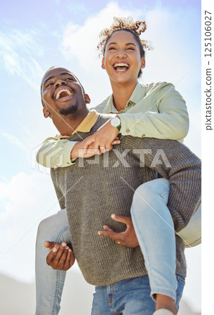Piggyback, laugh and and love with a black couple having fun together outdoor during a summer day. Dating, romance and carefree with a man carrying a woman on his back outside on holiday or vacation Piggyback, laugh and and love with a black couple having fun together outdoor during a summer day. Dating, romance and carefree with a man carrying a woman on his back outside on holiday or vacation 125106027
