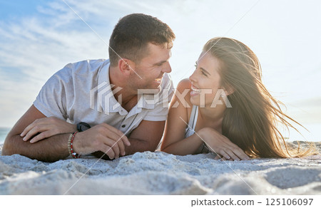 Love, ocean and couple laying on beach, man and woman relax on summer morning date. Travel, sea and happy couple on sand, spending time together in nature and romance on luxury vacation in Australia. 125106097