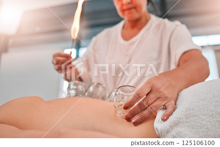 Relax, cupping massage and man at a spa for wellness, healing and holistic therapy with woman therapist. Hand cup therapy and fire treatment on client at resort for toxins, blood and circulation Relax, cupping massage and man at a spa for wellness, healing and holistic therapy with woman therapist. Hand cup therapy and fire treatment on client at resort for toxins, blood and circulation 125106100