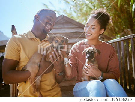 Dog, animal shelter and rescue with a black couple holding a puppy for adoption at a welfare kennel. Help, canine and volunteer with a man and woman adopting dogs from a charity organization 125106250