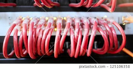 Technology, server room and cables connected to ethernet port or router for network, internet or fiber in data center for connection management. Electrical red optic cable for computer it background Technology, server room and cables connected to ethernet port or router for network, internet or fiber in data center for connection management. Electrical red optic cable for computer it background 125106358