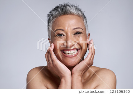 Beauty, skincare and portrait of senior woman in studio on gray background. Makeup cosmetics, smile and happy mature female model from India touching face for facial or healthy skin treatment routine Beauty, skincare and portrait of senior woman in studio on gray background. Makeup cosmetics, smile and happy mature female model from India touching face for facial or healthy skin treatment routine 125106360