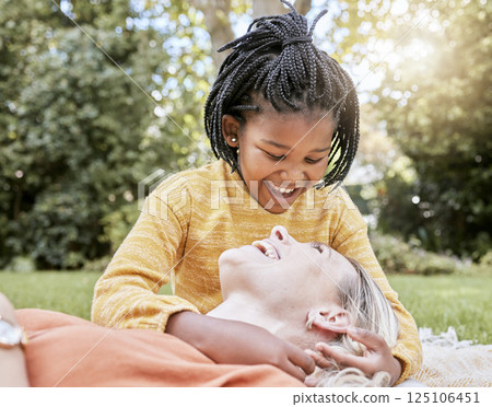 Family, adoption and park with a mother and daughter having fun while bonding during summer. Nature, love and diversity with a foster parent woman and girl child outdoor together with a smile 125106451