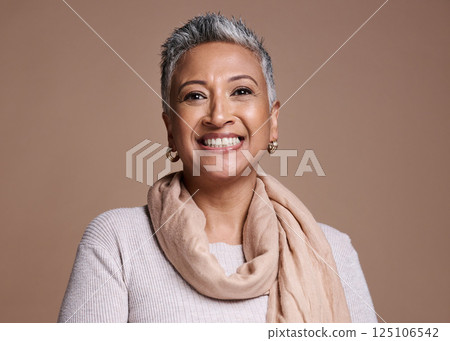 Face, fashion and beauty with a senior woman in studio on a brown background to promote contemporary style. Portait, fashionable and trendy with a mature female posing to model a clothes brand Face, fashion and beauty with a senior woman in studio on a brown background to promote contemporary style. Portait, fashionable and trendy with a mature female posing to model a clothes brand 125106542