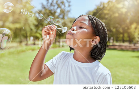 Park, child and black girl blowing bubbles enjoying fun time alone outdoors, joy and childhood development. Happy, freedom and kid learning and playing with soap bubble toy or wand and relax on grass Park, child and black girl blowing bubbles enjoying fun time alone outdoors, joy and childhood development. Happy, freedom and kid learning and playing with soap bubble toy or wand and relax on grass 125106608