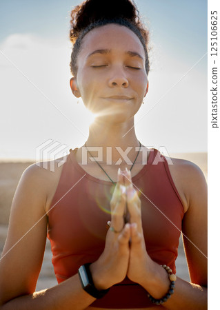 Yoga, pray hands and zen meditation or mental health in sunshine outdoors. Young woman relax, fitness and peace chakra or faith worship praying for balance, mindfulness and spiritual breathing 125106625