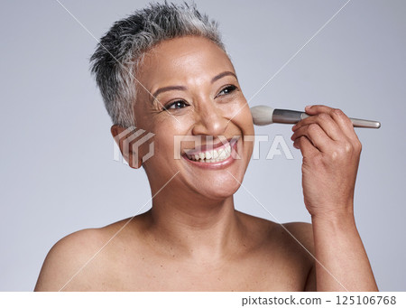 Brush, makeup and happy old woman in studio for a cosmetics, skincare beauty or luxury facial grooming. Smile, senior and excited face model enjoys applying foundation products in a self care routine Brush, makeup and happy old woman in studio for a cosmetics, skincare beauty or luxury facial grooming. Smile, senior and excited face model enjoys applying foundation products in a self care routine 125106768