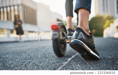Foot, scooter and travel of a person in the city traveling on eco friendly and sustainable transport. Feet, closeup and person riding e scooter with clean energy for a green carbon footprint 125106910