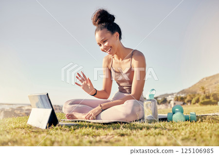 Fitness, woman and tablet call for yoga exercise, training or workout on the grass in the outdoors. Happy female waving for video call on touchscreen in spiritual wellness, zen or lifestyle in nature Fitness, woman and tablet call for yoga exercise, training or workout on the grass in the outdoors. Happy female waving for video call on touchscreen in spiritual wellness, zen or lifestyle in nature 125106985