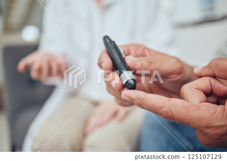 Finger, healthcare and diabetes with a senior man testing his blood sugar level while in his retirement home. Medical, wellness and test with a mature male using a glucometer to measure his glucose 125107129