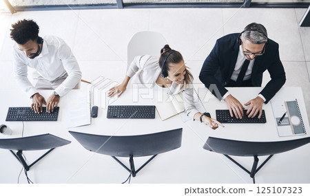 Above call center, team and office with crm, consultant and teamwork at desk, computer and help. Telemarketing, customer service and consulting group in workplace for customer support together online Above call center, team and office with crm, consultant and teamwork at desk, computer and help. Telemarketing, customer service and consulting group in workplace for customer support together online 125107323