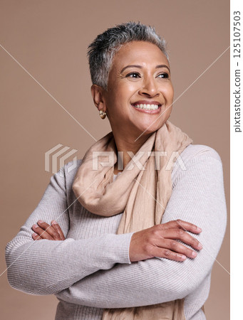 Fashion, thinking and style with a senior woman in studio on a brown background to model a contemporary brand. Idea, smile and trendy with a mature female posing to promote clothing or clothes 125107503