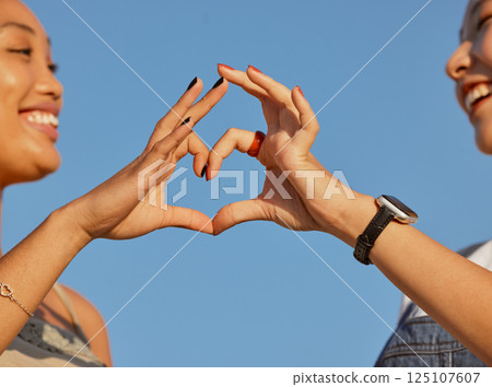Heart, love and friends with a sign of their support, trust and happy against a blue sky. Nature, care and women with emoji hands for travel natural environment and wellness in summer together Heart, love and friends with a sign of their support, trust and happy against a blue sky. Nature, care and women with emoji hands for travel natural environment and wellness in summer together 125107607