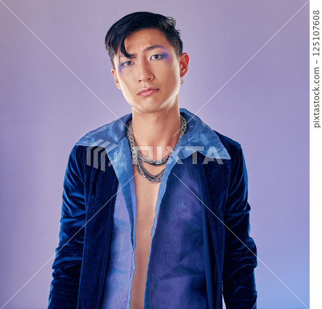 Asian man, makeup and punk fashion for portrait in studio with cyberpunk, creative or aesthetic face. Futuristic model, metal jewellery or clothes with art, cosmetic or beauty by lavender background Asian man, makeup and punk fashion for portrait in studio with cyberpunk, creative or aesthetic face. Futuristic model, metal jewellery or clothes with art, cosmetic or beauty by lavender background 125107608
