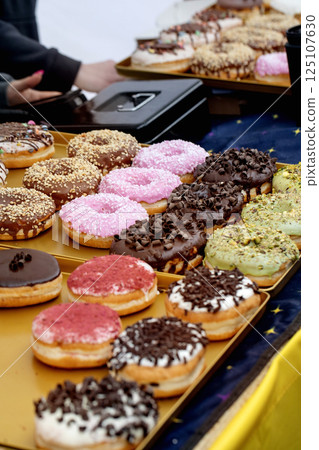 Colorful Donuts Display On Gold Tray 125107630