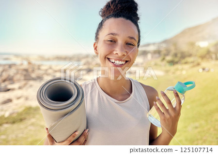 Nature, fitness and black woman with bottle and yoga mat ready to begin exercise, workout and training. Summer, yoga and portrait of young female with water exercising for health wellness by ocean 125107714