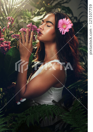 Young woman, nature and smell flowers, plants and content with environment, happy and peaceful outdoor. Female, girl and happiness, natural aroma, fragrance or tranquil for scent, serene and floral. 125107759