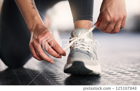 Woman, hands and shoelace tie for gym workout, training or exercise in wellness, health or fitness club. Zoom, personal trainer and coach legs with sports shoes, body goals and challenge motivation 125107848