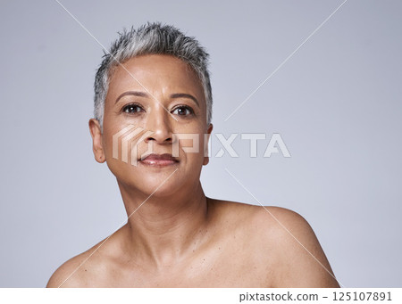 Makeup, cosmetics and senior woman with dermatology for face, skin and wellness against a grey mockup studio background. Beauty, skincare and portrait of the face of an elderly model with health 125107891