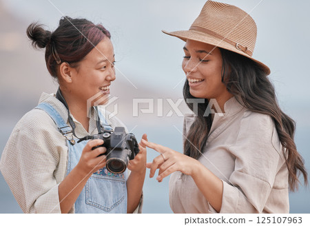 Photo, photographer and model with a camera for a photo shoot at the beach, nature or during travel of Portugal together. Decision, choice and friends happy with outdoor photography on vintage camera 125107963