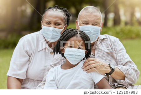Family portrait, covid and face mask outdoor at nature park with child and grandparents together on picnic for love, care and summer bonding. Man, woman and girl with covid 19 safety compliance 125107998