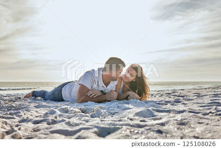 Couple, love and sunset, beach while on a summer vacation to relax on sand together for travel, happiness and freedom outdoor. Man and woman in healthy marriage with trust and support by the sea 125108026