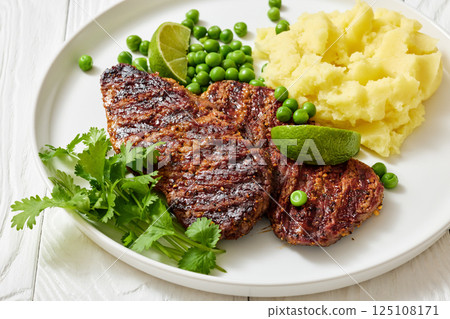 grilled beef cutlets with potato mash, green peas grilled beef cutlets with potato mash, green peas 125108171