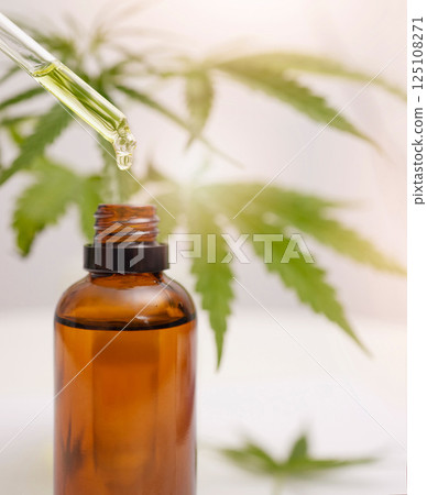 Cbd oil, hemp and cannabis leaf and dropper bottle for stress, healthcare and holistic use. Marijuana, 420 and weed plant leaf with liquid product for depression, anxiety and sleep production 125108271