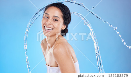 Beauty, splash and black woman in studio portrait for cleaning body or skincare promotion with water on blue mockup. Face, skin care model with water drops or shower in bathroom for morning facial Beauty, splash and black woman in studio portrait for cleaning body or skincare promotion with water on blue mockup. Face, skin care model with water drops or shower in bathroom for morning facial 125108279