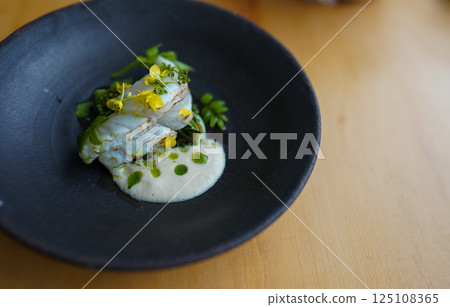 Spring appetizer of fish and wild vegetables 125108365