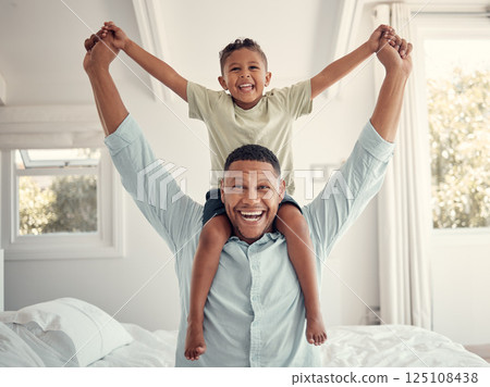 Father, child and smile for bedroom piggyback relaxing or fun playful bonding together at home. Happy dad and kid holding hands on shoulders for family time, relax and playing joy on the bed indoors Father, child and smile for bedroom piggyback relaxing or fun playful bonding together at home. Happy dad and kid holding hands on shoulders for family time, relax and playing joy on the bed indoors 125108438