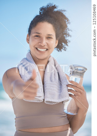 Thumbs up, water bottle and black woman in fitness, workout or training success, achievement and goal. Sports, runner girl on beach portrait with thank you, yes and like hand sign for healthy life Thumbs up, water bottle and black woman in fitness, workout or training success, achievement and goal. Sports, runner girl on beach portrait with thank you, yes and like hand sign for healthy life 125108469