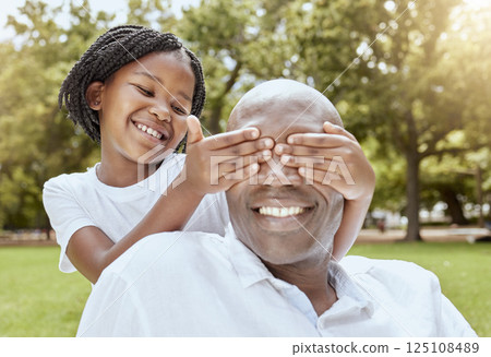 Park, surprise and girl with happy dad, hands over eyes and playing at picnic in garden. Nature, love and family, young child and black man on grass for family fun in summer, spending time together. Park, surprise and girl with happy dad, hands over eyes and playing at picnic in garden. Nature, love and family, young child and black man on grass for family fun in summer, spending time together. 125108489