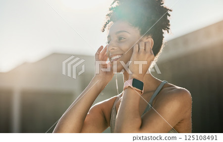 Fitness, music and black woman doing exercise in city with earphones, smile and ready for training. Workout, running and young female athlete doing sports in town listening to track, audio and radio 125108491