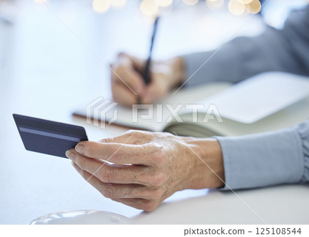 Credit card, accountant woman and hands writing bank information in notebook for payment details in an office for finance management. Business woman or bookkeeping while making note for banking 125108544