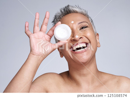 Mature woman, laughing and skincare cream in healthcare grooming, collagen glow wellness or facial dermatology routine. Smile, happy or beauty model with sunscreen product on Indian studio background Mature woman, laughing and skincare cream in healthcare grooming, collagen glow wellness or facial dermatology routine. Smile, happy or beauty model with sunscreen product on Indian studio background 125108574