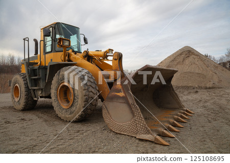 Heavy-Duty Yellow Loader with Large Shovel on Construction Site 125108695
