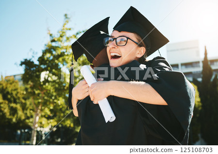 Hug, graduation and students smile, success for achievement and happy outdoor in gown. Female graduate, embrace and completed degree for education, certificate and diploma at university and college. Hug, graduation and students smile, success for achievement and happy outdoor in gown. Female graduate, embrace and completed degree for education, certificate and diploma at university and college. 125108703