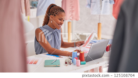 Black woman, fashion and design on laptop for marketing, advertising or social media at the office. Creative African American female employee designer working on computer for clothing inspiration Black woman, fashion and design on laptop for marketing, advertising or social media at the office. Creative African American female employee designer working on computer for clothing inspiration 125108704
