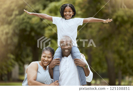 Portrait of a happy black family in nature to relax bonding in freedom, wellness and peace together in a park. Mother, father and child loves flying, hugging or playing outdoors enjoying quality time Portrait of a happy black family in nature to relax bonding in freedom, wellness and peace together in a park. Mother, father and child loves flying, hugging or playing outdoors enjoying quality time 125108851
