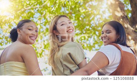 Young women, friends and smile in park portrait together in diversity, happy and summer by trees. Group, woman and happiness in freedom on vacation, holiday or walking in nature by tree in sunshine 125108888