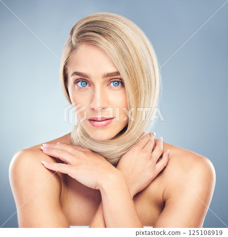 Beauty, blonde hair and portrait of woman in studio on blue background for hair care, hair products and hair salon. Fashion, style and young female with healthy, smooth and perfect hair around neck 125108919