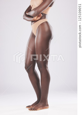 Legs, skincare and black woman in underwear in studio isolated on gray background mockup. Beauty fashion, wellness or body care of young, healthy or slim female fitness model posing with arms crossed 125109051