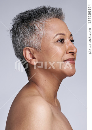 Beauty, woman and skincare, face and antiaging with healthy skin motivation and facial treatment against studio background. Natural cosmetics advertising with mature model, grooming and fresh glow. Beauty, woman and skincare, face and antiaging with healthy skin motivation and facial treatment against studio background. Natural cosmetics advertising with mature model, grooming and fresh glow. 125109164