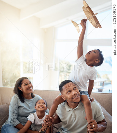 Happy family playing living room with toy airplane for fun games, freedom and energy together in family home. Parents, kids and flying aeroplane toys to dream for travel, easy lifestyle and happiness Happy family playing living room with toy airplane for fun games, freedom and energy together in family home. Parents, kids and flying aeroplane toys to dream for travel, easy lifestyle and happiness 125109176