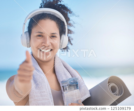 Thumbs up, woman and headphone, fitness and exercise, yoga and motivation in Miami. Portrait of happy fitness female celebration, success and excited goal for achievement, yes sign and like emoji 125109179