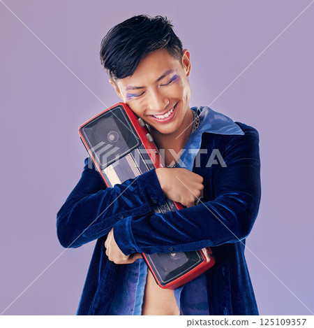 Retro, disco and boom box with asian man and punk makeup for music, creative and festival event. Art, dj and techno with guy and stereo speaker for vintage, cosmetics and rock in purple background 125109357