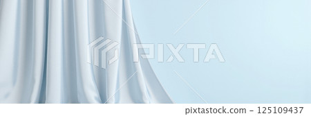 Elegant smooth fabric folds in soft pale blue color background for product mockup design banner presentation layout 125109437