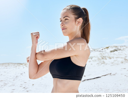 Woman, stretching arm and beach fitness for body health, wellness and happy training in nature in summer. Fitness female, warm up and morning workout with happiness, calm mindset and commitment 125109450